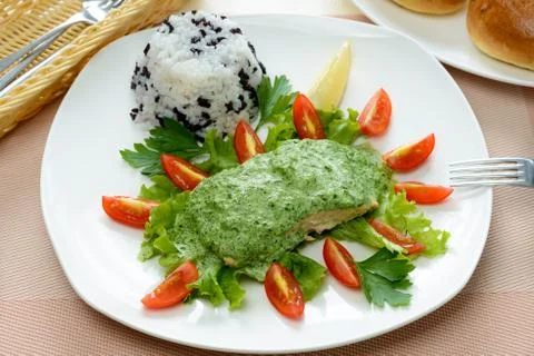 Salmon with spinach sauce Stock Photos