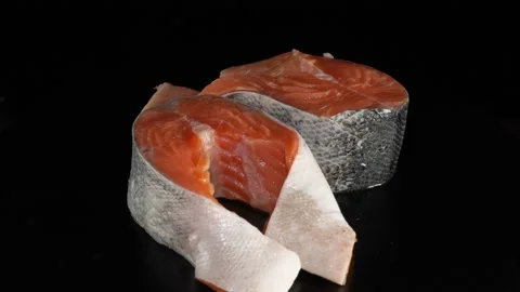 Salmon steak close-up on a dark background. 動画素材 140797948