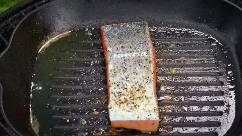 Salmon steak is frying on a pan. Video stock 324583655