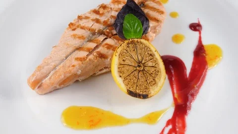 Salmon steak grilled with lemon, served in Restaurant or Pub Stock Footage 79713575