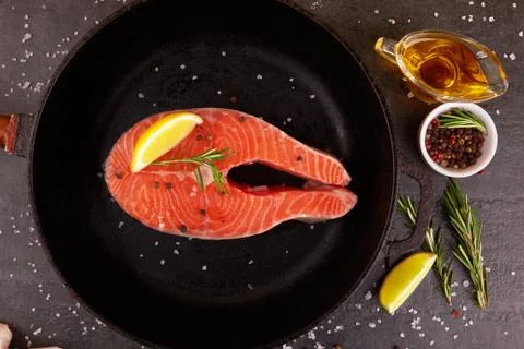 Salmon steak on pan Stock Photos