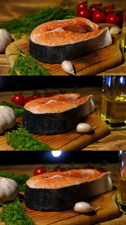 Salmon steak. Raw salmon steak with dill, garlic and olive oil is rotating on a Stock Footage 304148566