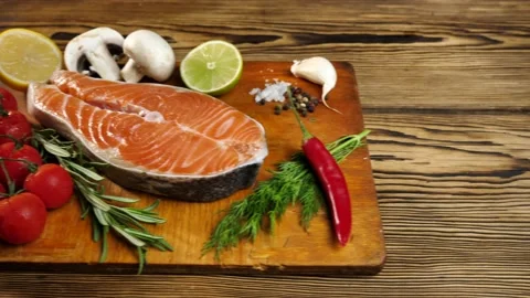 Salmon steak. Raw trout red fish steak with dill, garlic, rosemary, garlic Stock Footage 215655083