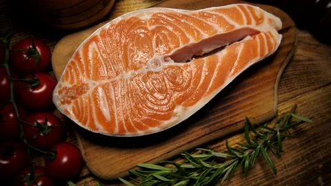 Salmon steak. Red fish steak made from raw salmon, olive oil, spices and herbs Stock Footage 211872079