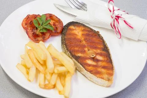 Salmon steak served with chip Stock Photos