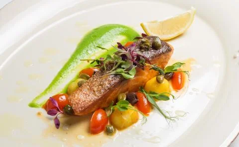 Salmon steak with vegetables Stock Photos