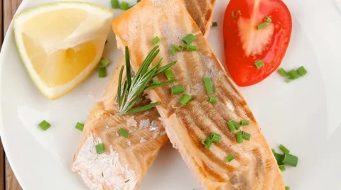 Salmon steaks on white dish Видео 59537291