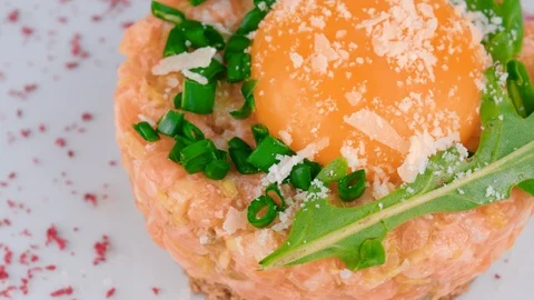 Salmon tartar, close-up view, egg yolk on top, parmesan cheese Stock Footage 95146892