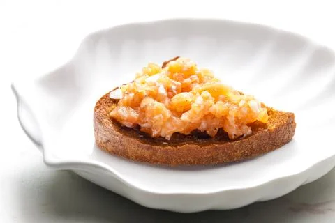 Salmon tartar on fried bread Stock Photos