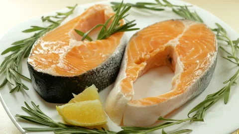 Salmon. Two Raw Trout Red Fish Steak with Herbs and Lemon. Cooking Salmon, sea f Stock Footage 97796378