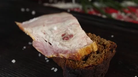 Salo falls on bread in slow motion Stock Footage 259644205