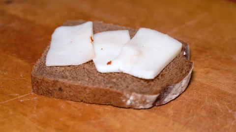 Salo is put black bread. Ukrainian traditional food - salo Stock Footage 249538178