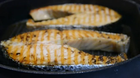 Salomon steak on grill pan. close up selective focus. Stock Footage 120572360