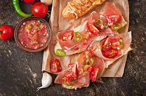 Salsa dip in bowl of bread and cheese sticks on wooden background Stock Photos