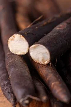 Salsify roots on a board Stock Photos