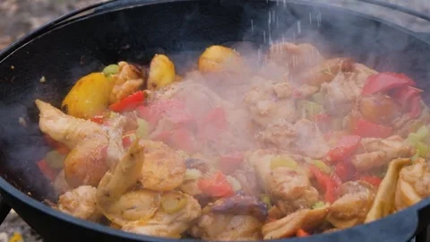 Salt is added to the dish in the cauldron, slow motion. Frame of adding salt to Stock-Footage 278463447