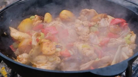 Salt is added to the dish in the cauldron, slow motion. Frame of adding salt to Stock Footage 279271762
