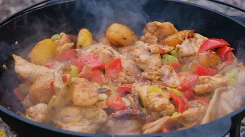 Salt is added to the dish in the cauldron, slow motion. Frame of adding salt to Stock Footage 280213804