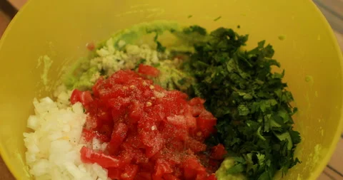 Salt and pepper chopped vegetables, prepare guacamole Video stock 244423786