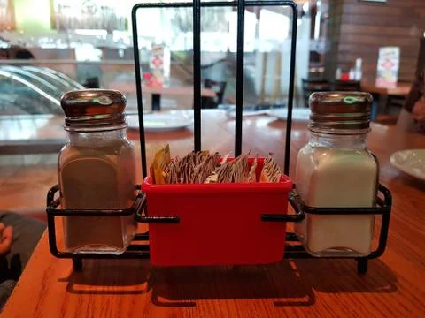 Salt and pepper container on a table in a restaurant Fotos de archivo