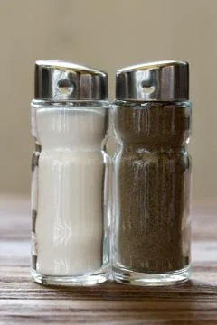 Salt and pepper set-tableware closeup on wooden surface Stock Photos