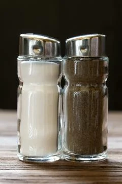 Salt and pepper set-tableware on dark background Stock Photos