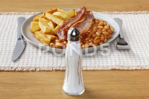 Salt and a salty greasy meal Stock Photos