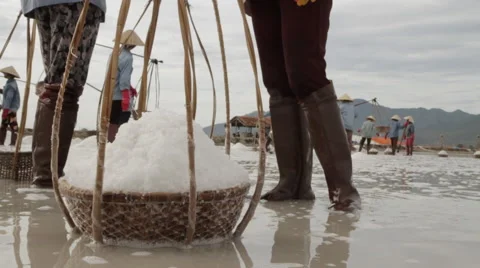 Salt Basket in Foreground Worker in Background Stock Footage 42436593