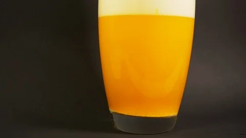 Salt bath yellow dissolves in vase of water slow motion with particle drill Stock Footage 119542669