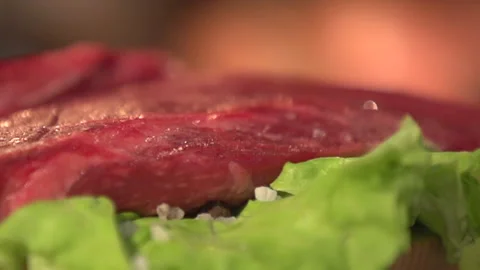 Salt is being poured onto the beef in lettuce, left panorama Stock Footage 113552878
