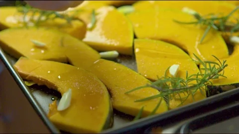 Salt being sprinkled on pumpkin slice Stock Footage 76133354