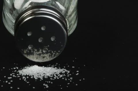 Salt on black background Stock Photos