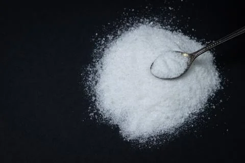 Salt on a black background. Stock Photos