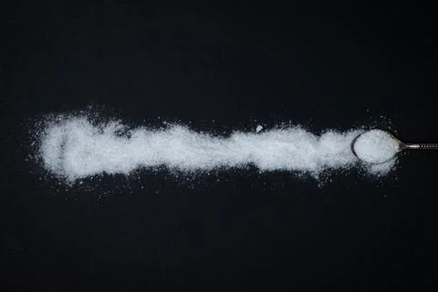 Salt on a black background. Stock Photos