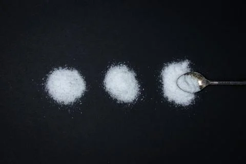 Salt on a black background. Stock Photos