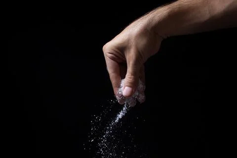 Salt on a black background. Stock Photos