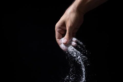 Salt on a black background. Stock Photos