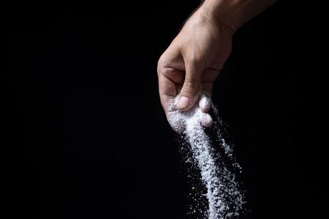 Salt on a black background. Stock Photos