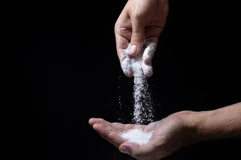 Salt on a black background.  Stock Photos