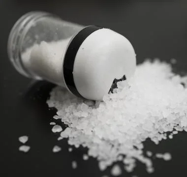 Salt on black Stock Photos