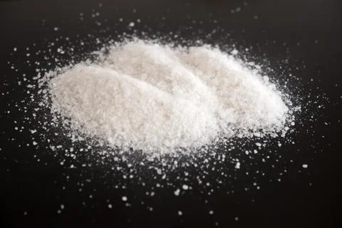 Salt on black Stock Photos