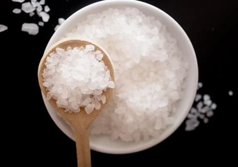 Salt on black Stock Photos