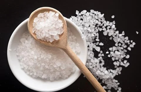 Salt on black Stock Photos