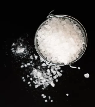 Salt on black Stock Photos