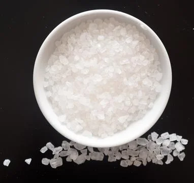 Salt on black Stock Photos