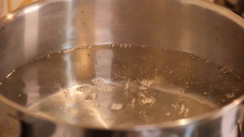 Salt in the boiling pot Stock Footage 97974791