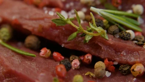 Salt close-up sips on a piece of fresh raw beef meat. Stock Footage 90495445