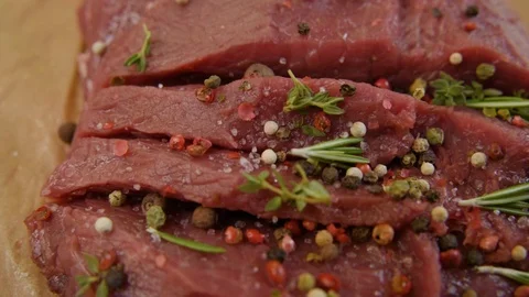Salt close-up sips on a piece of fresh raw beef meat. Stock-Footage 90495459