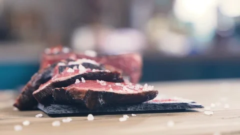Salt close-up sips on a piece of fresh raw beef meat Vidéo 107739582