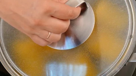 Salt corn in a saucepan Stock Footage 84278563